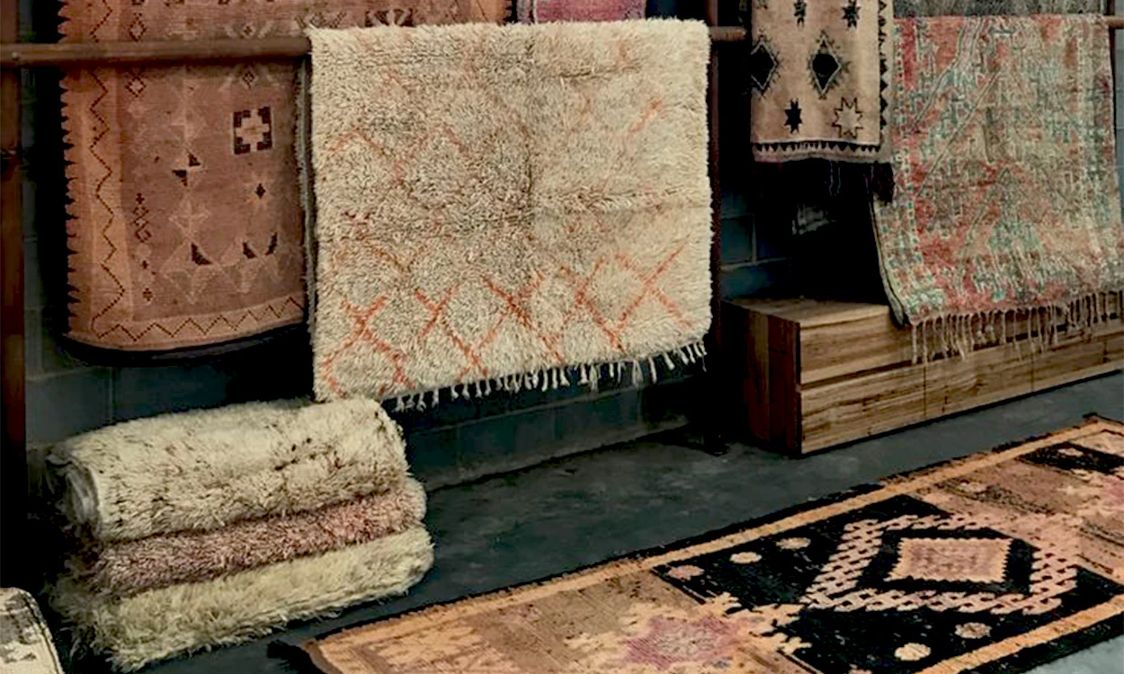 Split image showing the same room styled with Moroccan textiles for different seasons - a plush Beni Ourain rug for winter and lightweight kilim for summer