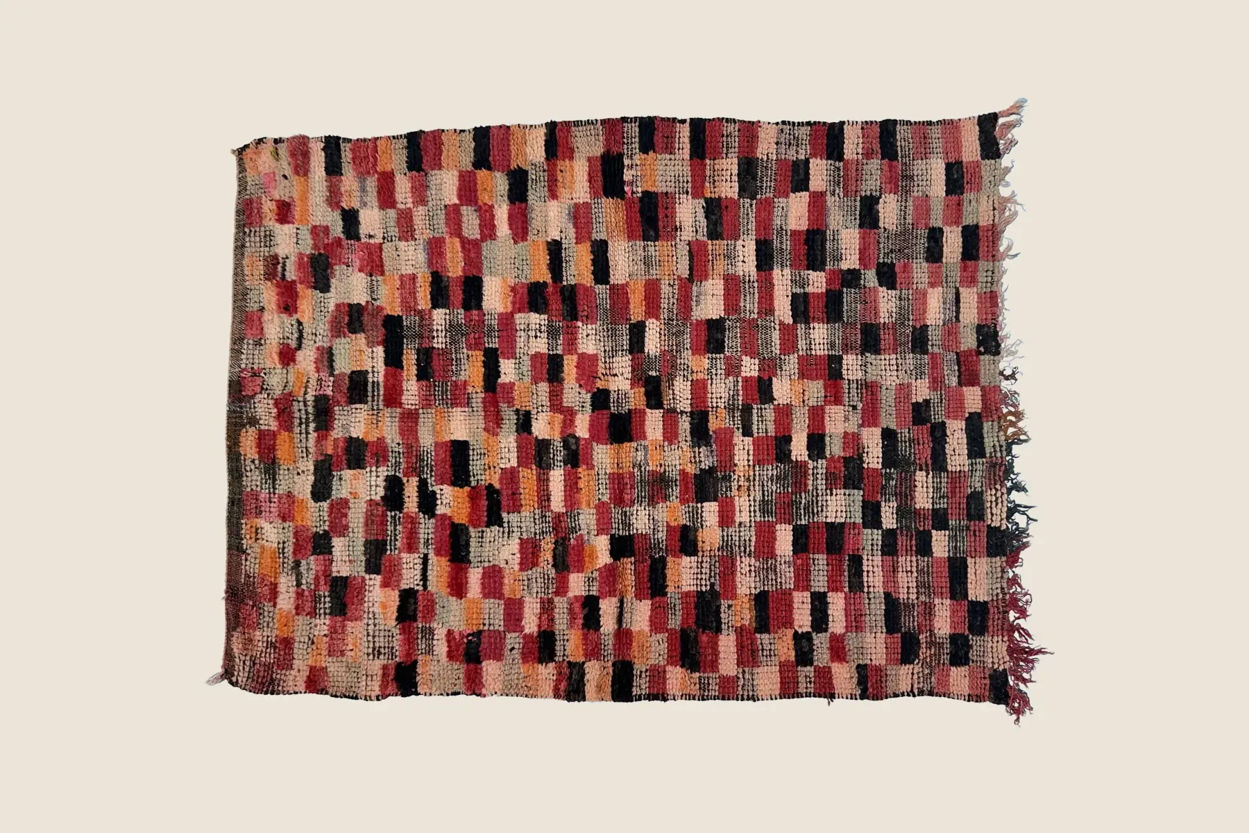 Beni M'Guild wool texture detail showing hand-knotted crimson, beige, gray & orange geometric motifs