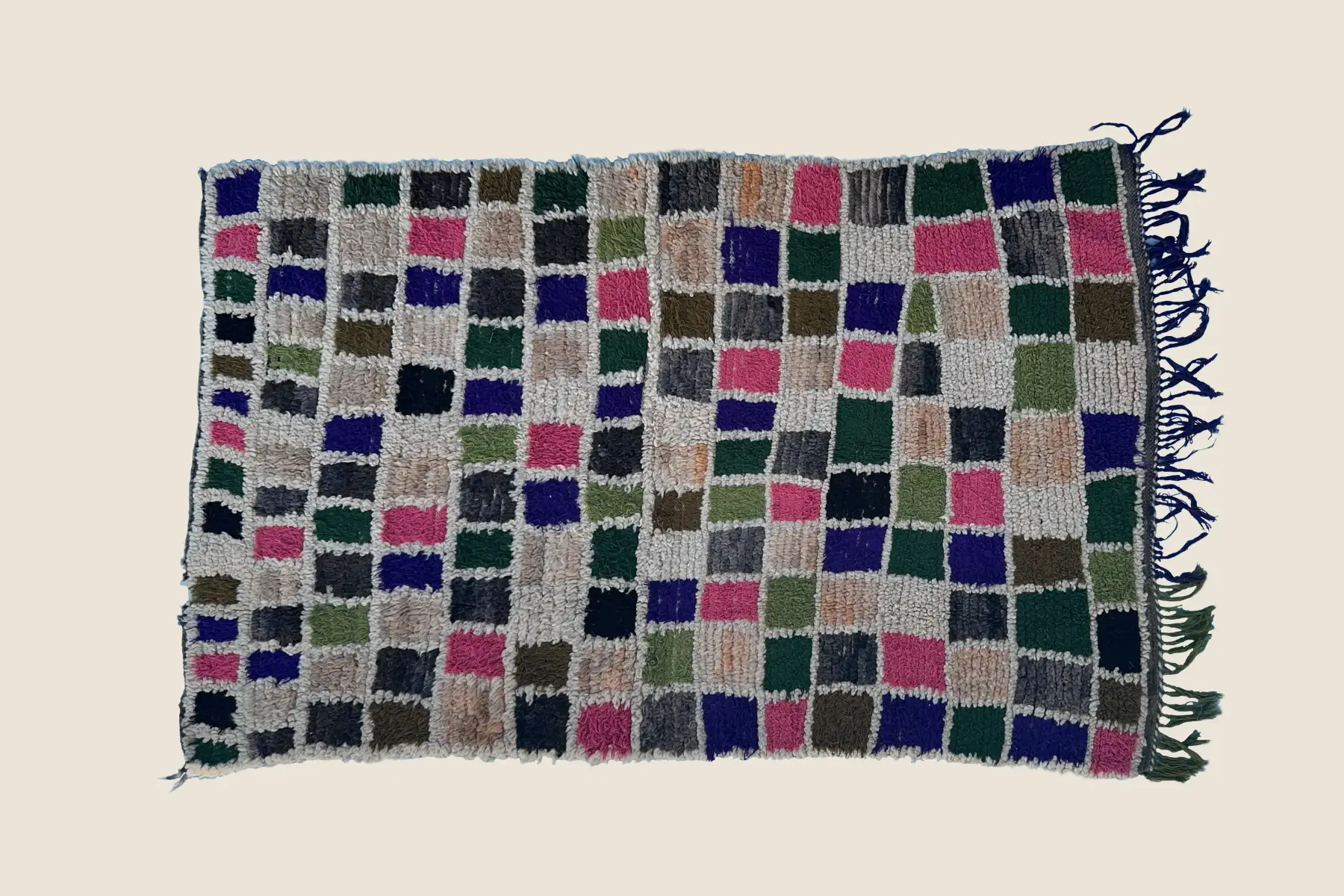 Beni M'Guild wool texture detail showing hand-knotted geometric motifs in golden brown and deep violet