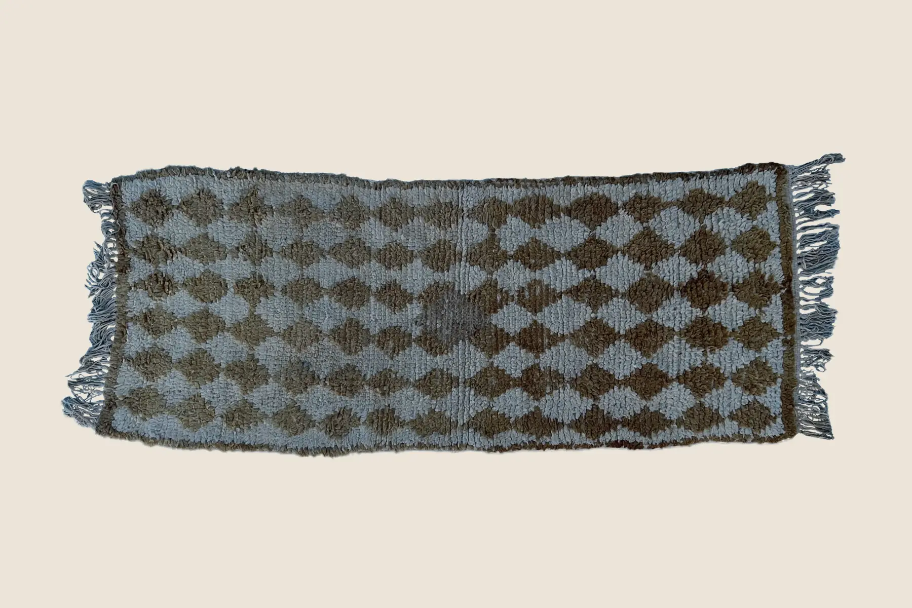 Beni M'Guild wool texture detail showing light gray-green and beige stripes with hand-woven craftsmanship