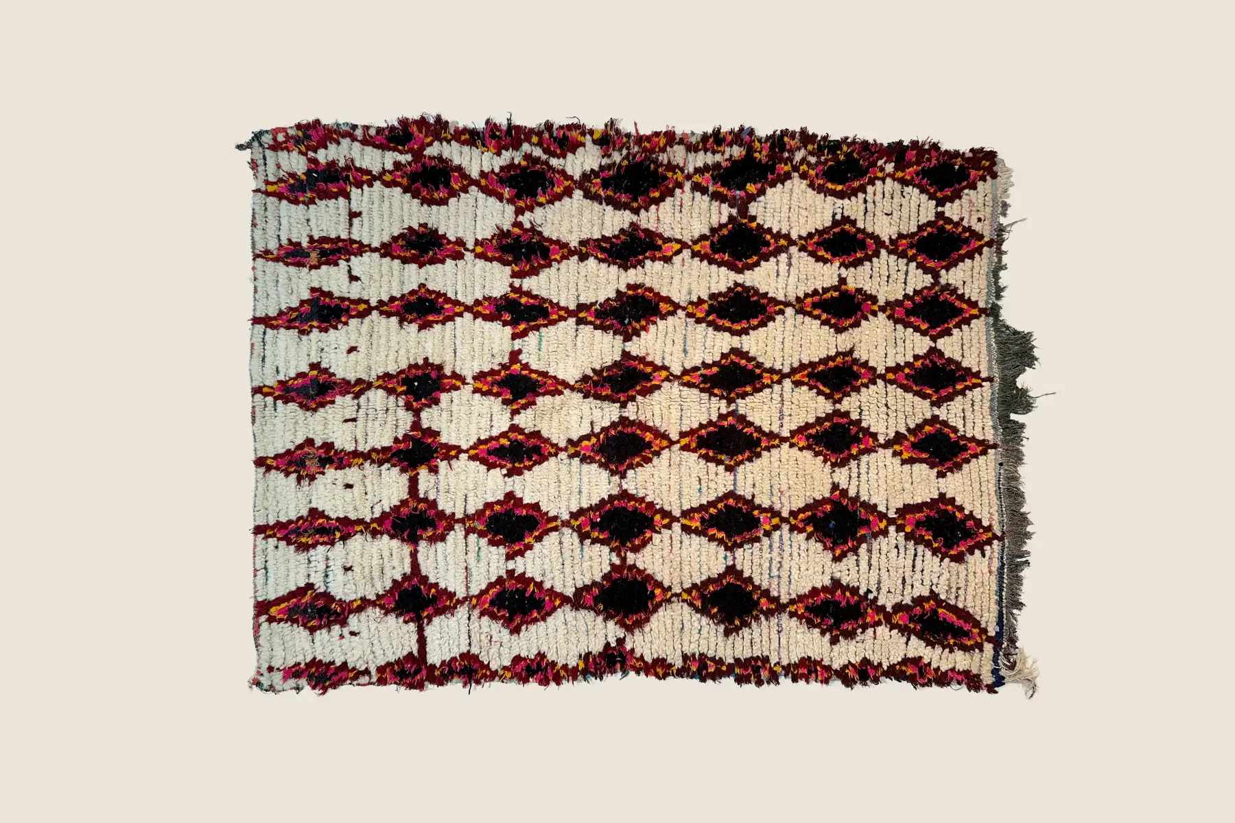 Azilal rug detail showing hand-spun wool texture in charcoal gray and vivid magenta colors