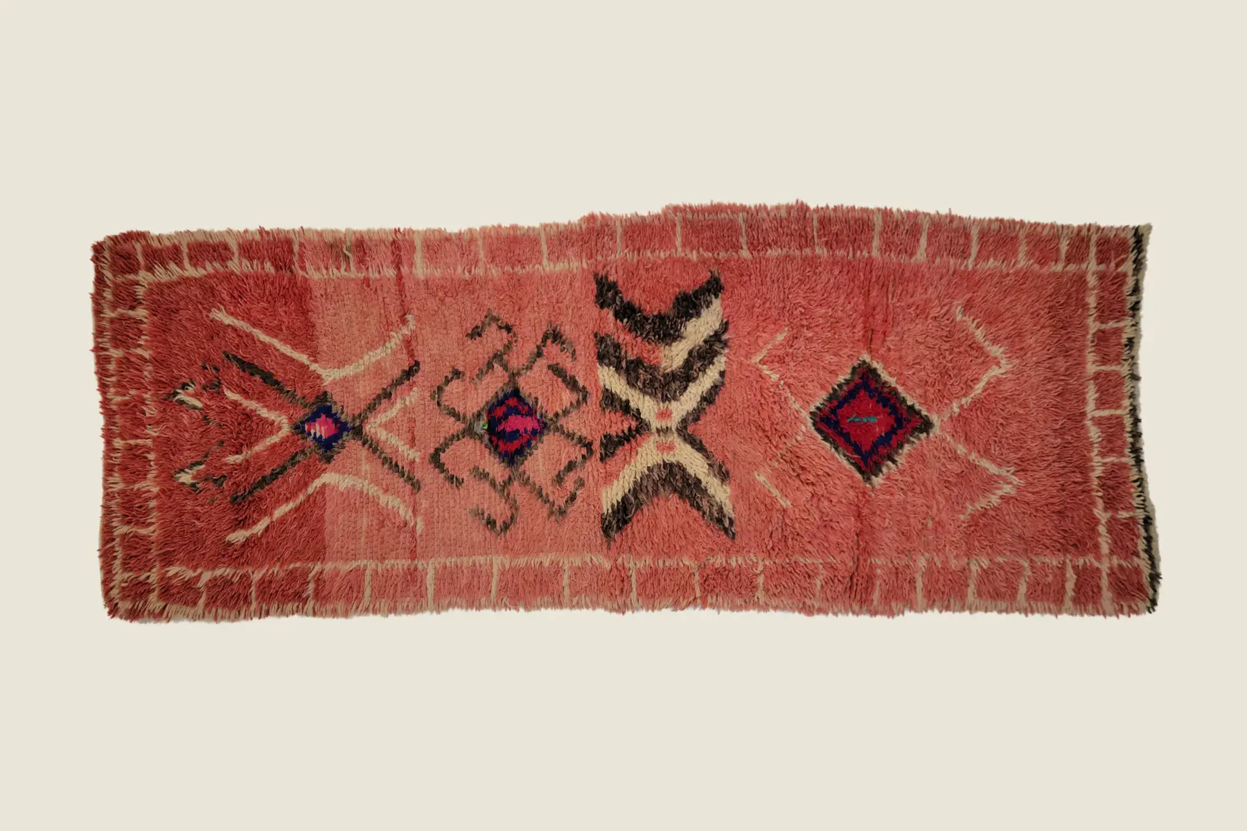Beni M'Guild hand-knotted texture detail showing terracotta wool pile and traditional weaving craftsmanship
