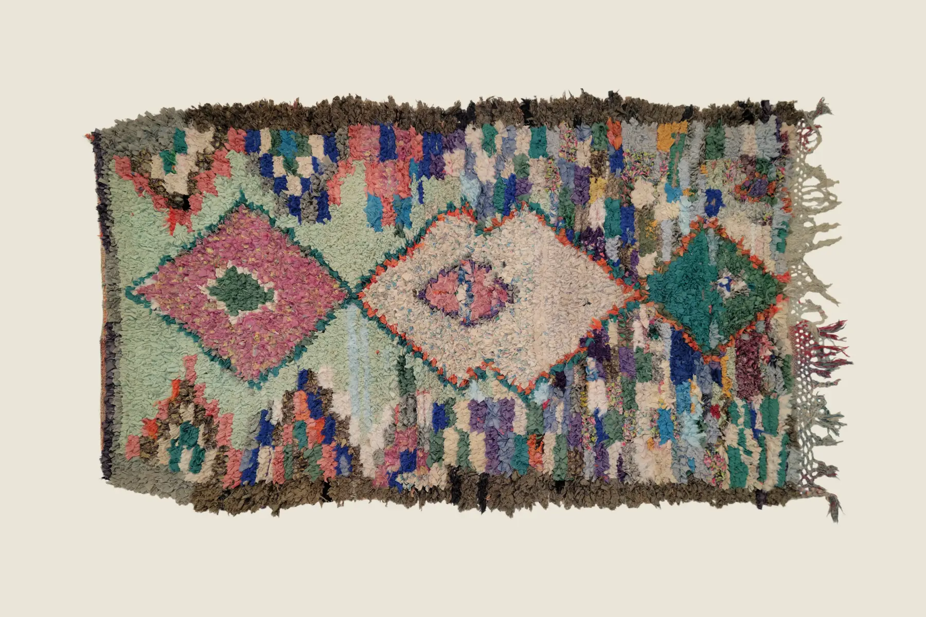 Boucherouite recycled textile detail showing dusty rose and sage green shag texture - handcrafted