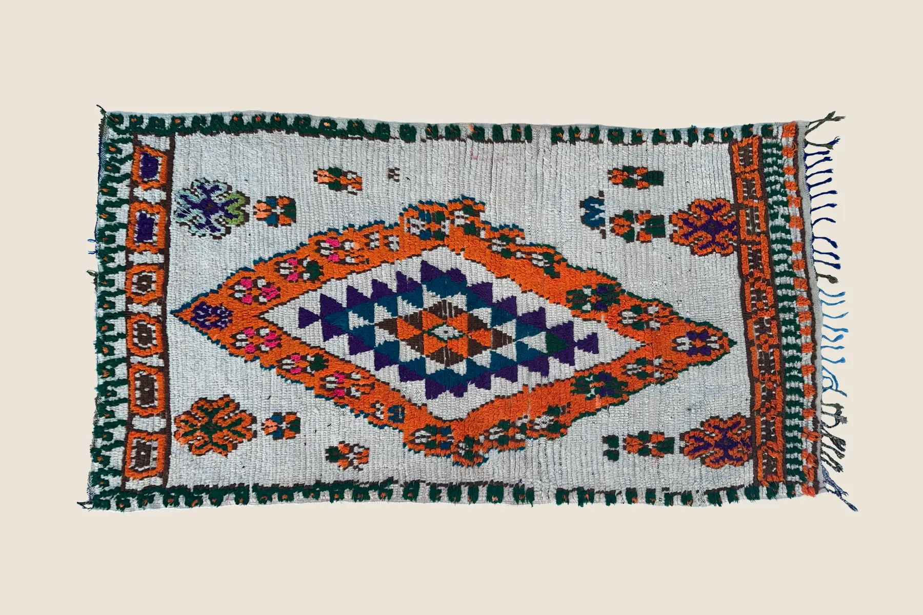 Beni M'Guild rug detail showing hand-knotted wool pile with gray, teal, and orange accents - traditional Moroccan weaving craftsmanship