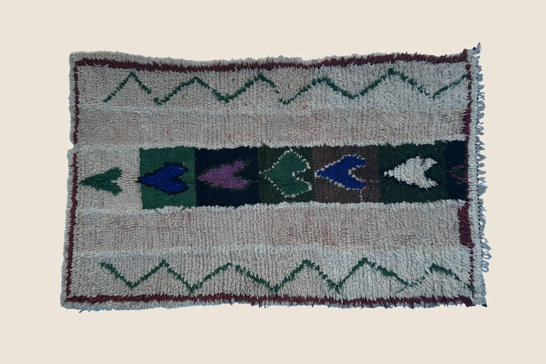 Beni M'Guild rug detail showing hand-knotted wool texture with light gray, teal, and brown geometric motifs - artisan weaving craftsmanship