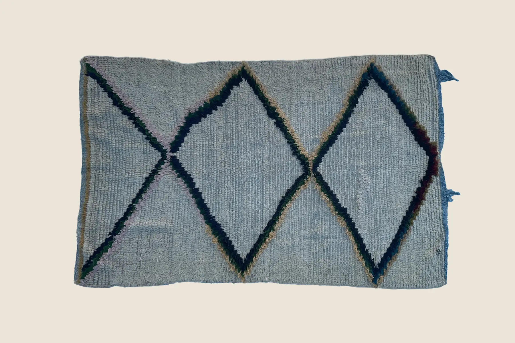 Beni M'Guild hand-knotted wool detail showing slate blue and teal geometric motifs with natural dye variations