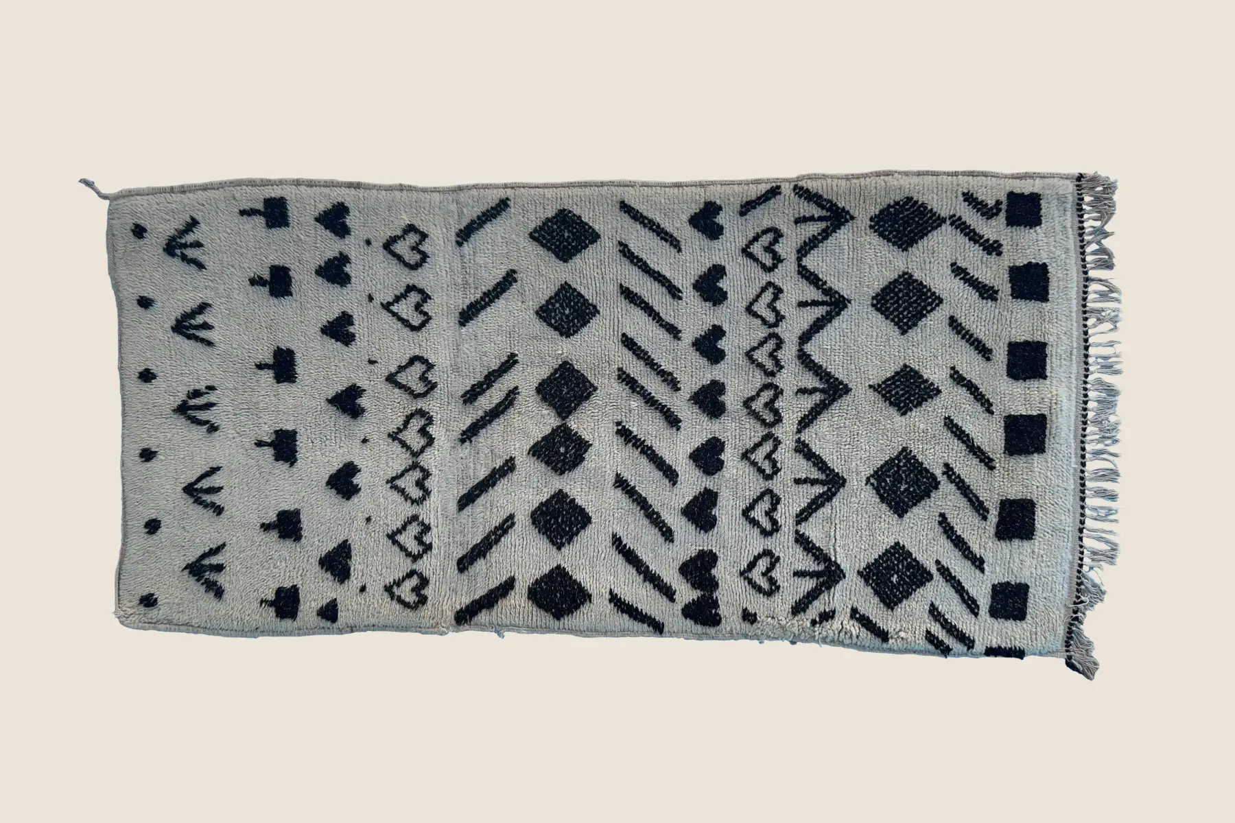 Beni M'Guild rug texture detail showing hand-knotted charcoal and warm gray wool weave craftsmanship