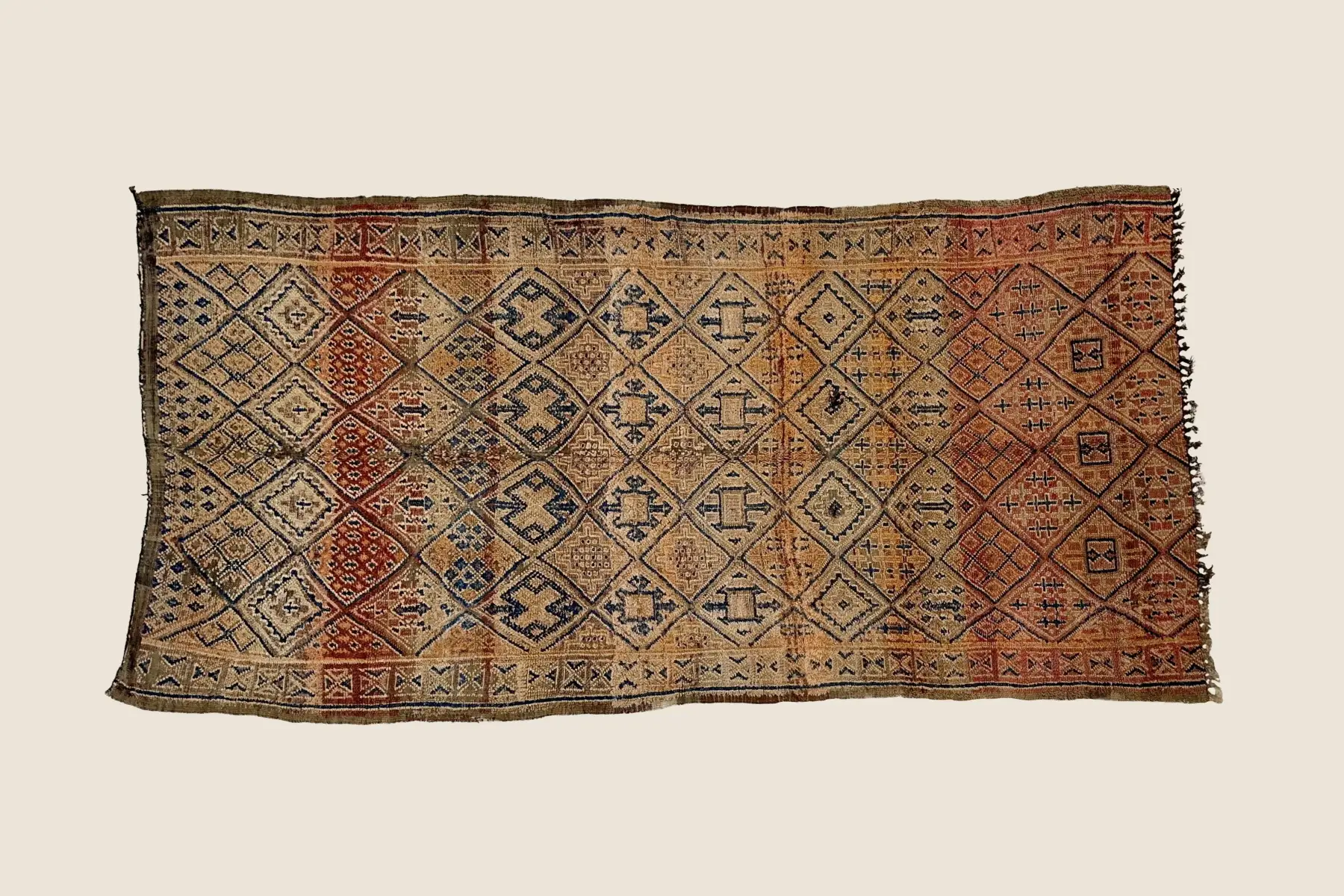 Beni M'Guild handwoven wool detail showing terracotta and gray geometric pattern with natural dye variations and tight knot craftsmanship