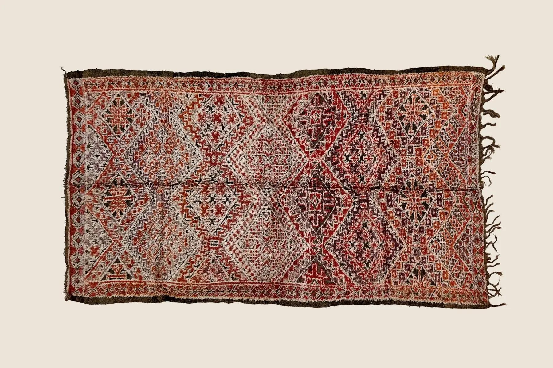 Marmoucha rug detail showing hand-knotted wool texture with dark red and warm beige pattern variations