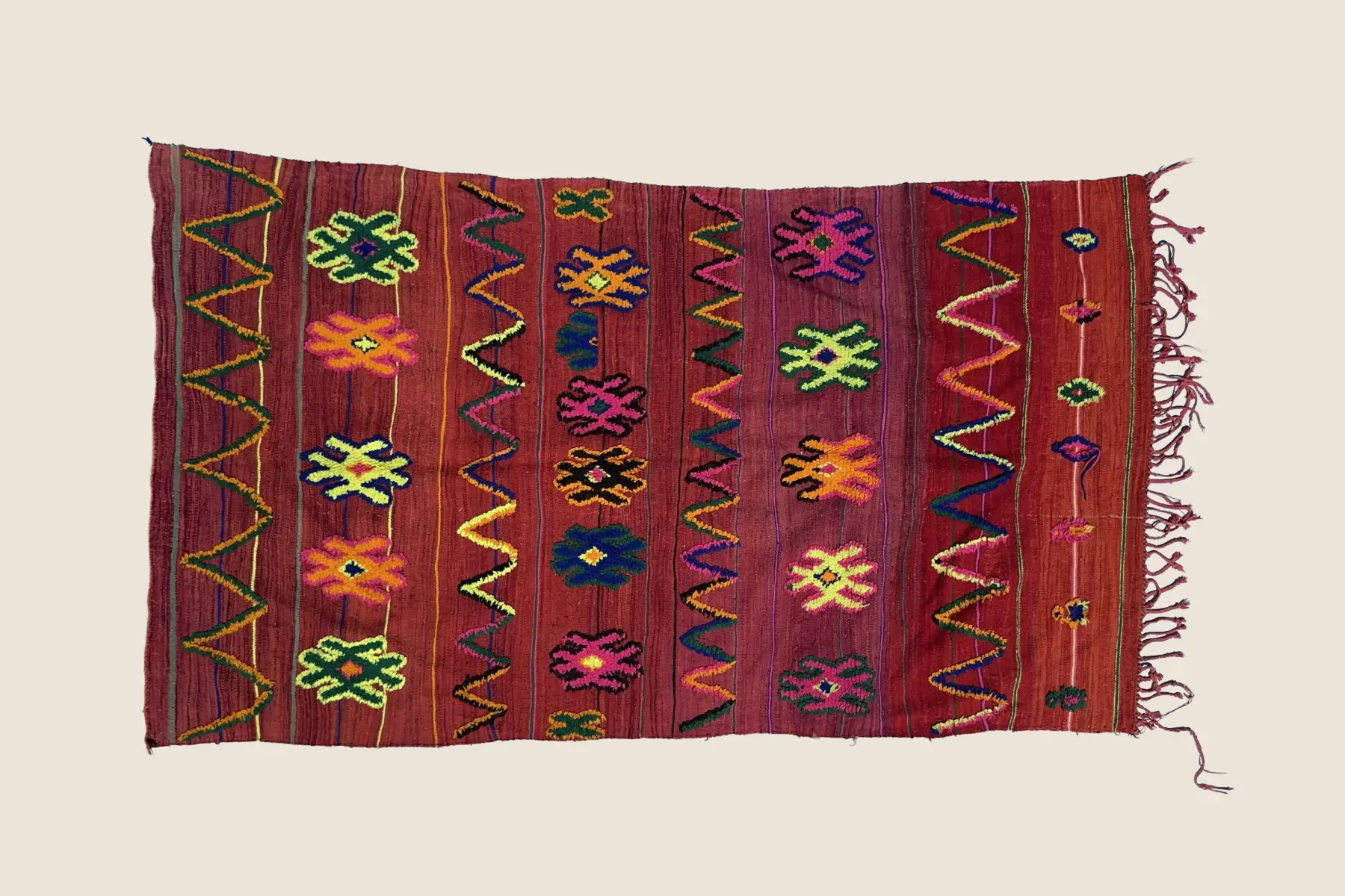 Talsint rug detail showing tight hand-knotting and texture of dark blue, teal, and magenta Moroccan wool craftsmanship