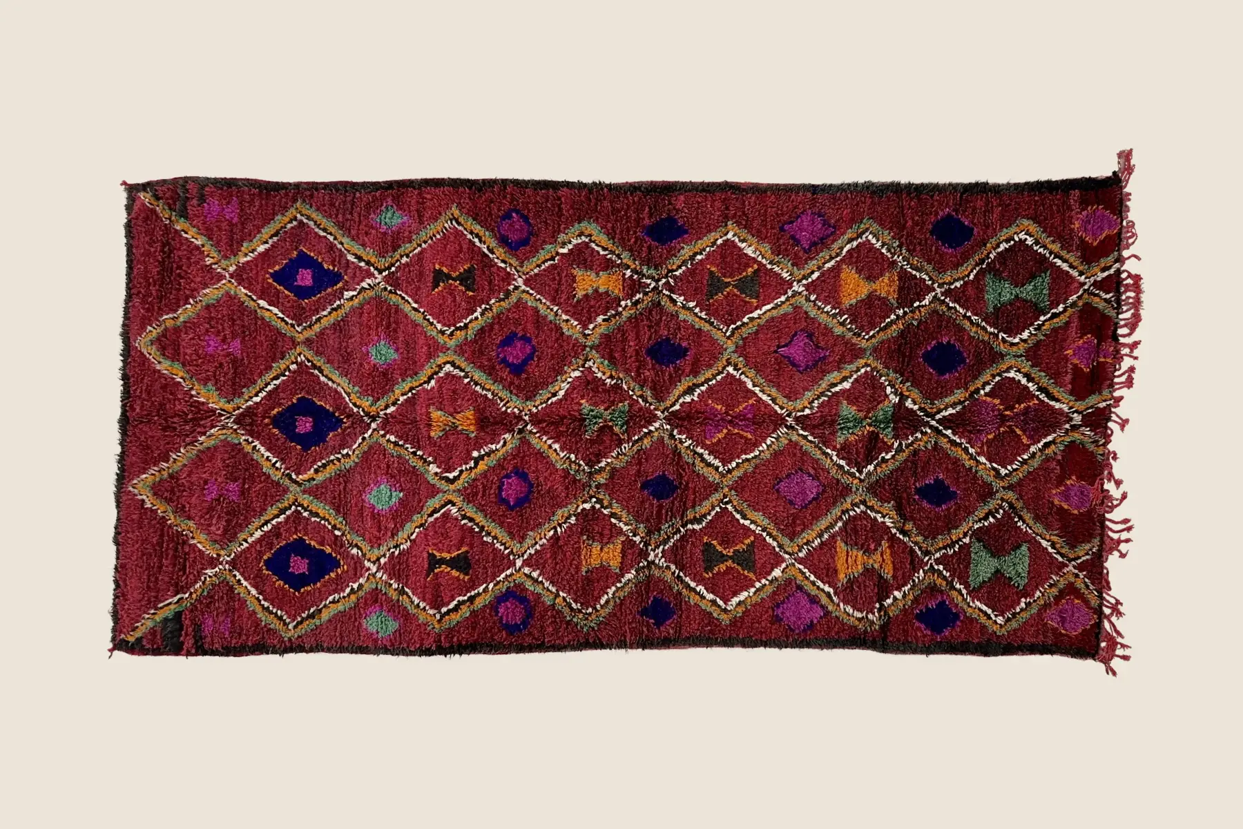 Talsint rug detail showing deep violet and magenta wool texture with hand-knotted craftsmanship