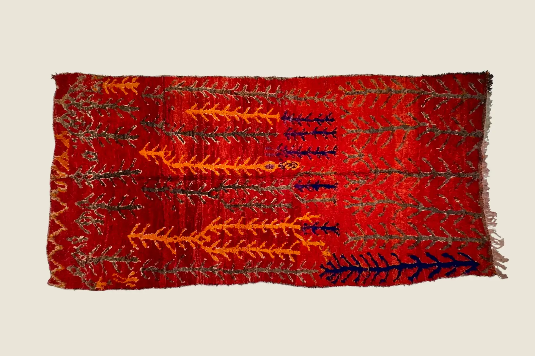 Talsint rug texture detail showing vivid red and orange hand-weaving craftsmanship.
