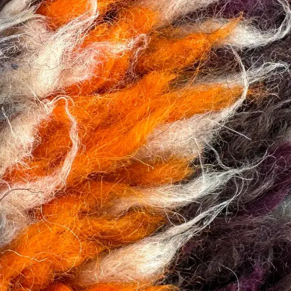 A color swatch labeled Warm Orange from the Atlas product line, showing a vibrant orange hue.