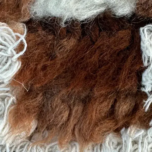 Dark brown color swatch from the orange family, shown for the Beni M'guild Rug in Midnight Blue and Warm