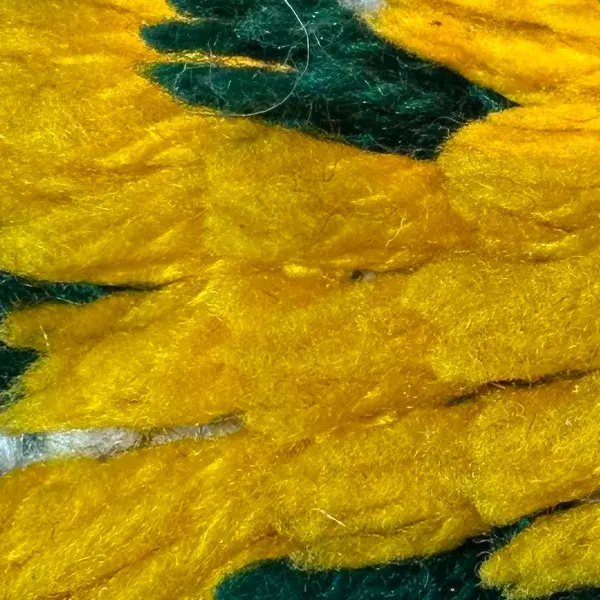 A mustard yellow swatch from a tribal wool rug.