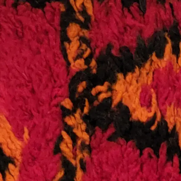 Dark warm brown color swatch for a diamond-patterned rug with black and red.