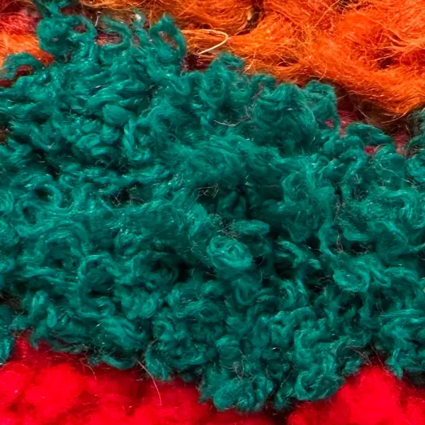 A deep teal green diamond symbol.