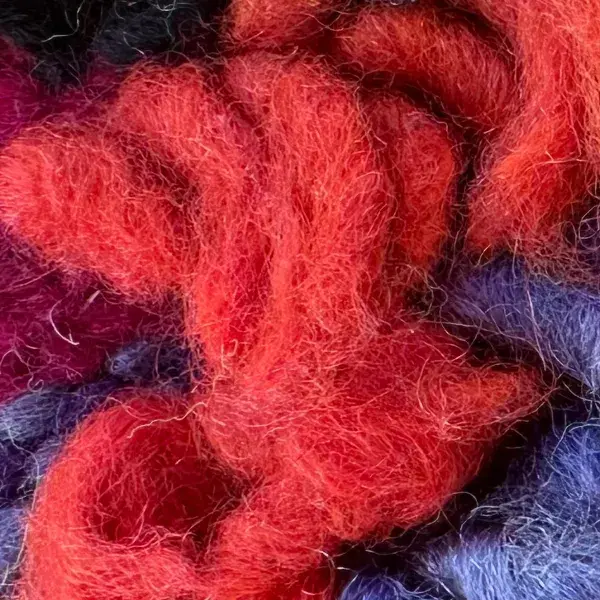 A color swatch labeled Warm Coral Red from the Talsint product line, showing a vibrant reddish-coral shade.