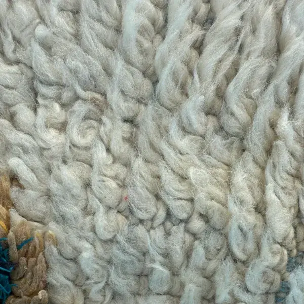 Handwoven Atlas rug in slate blue with light gray accents, showcasing a textured gray family palette.
