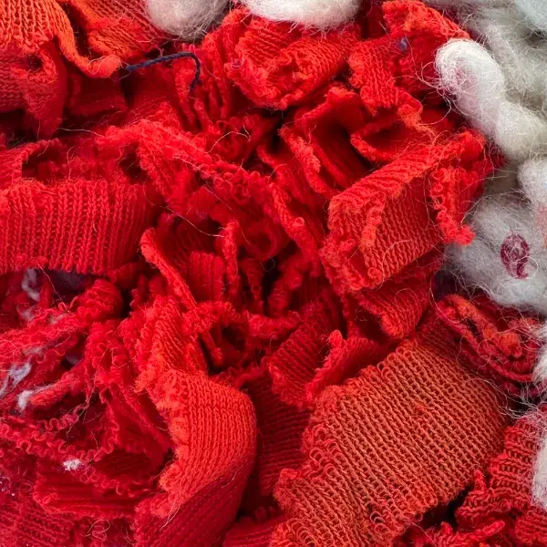 Vivid red color swatch from the Atlas product line, RGB 218, 19, 39.