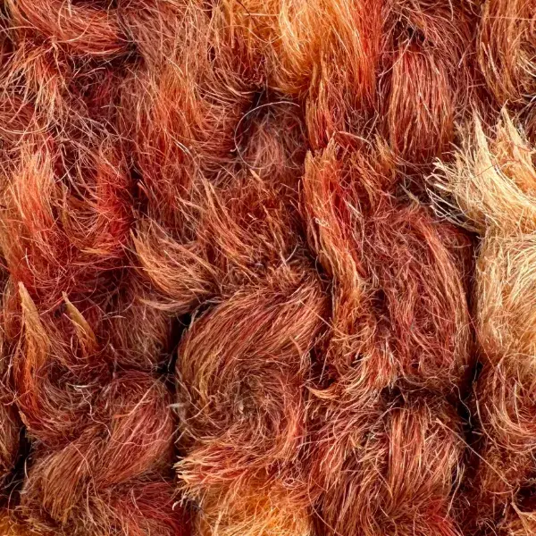 A warm terracotta orange color swatch from the Beni Mguild product line.