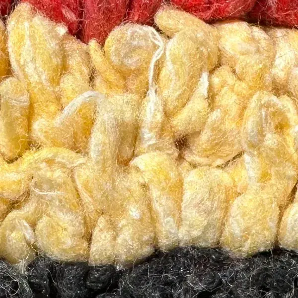 A warm beige color swatch from the yellow family, part of the Atlas product line.