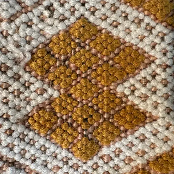 Dark golden brown diamond symbols on an orange background.