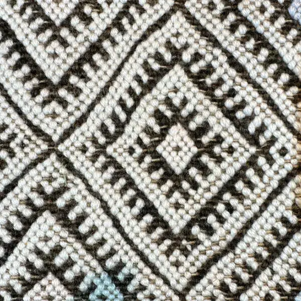 Light gray diamond symbol on a white background