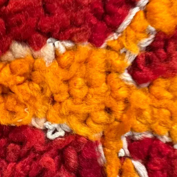 Vibrant orange color swatch for a red rug with gazon symbols.